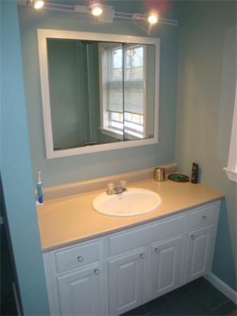 106 Desoto Road Boston, MA 02132 - Photo 14 of 27 a bathroom with a granite countertop sink and a bathtub