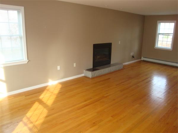 106 Desoto Road Boston, MA 02132 - Photo 7 of 27 a view of empty room with wooden floor and fan