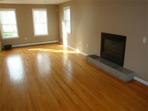106 Desoto Road Boston, MA 02132 - Photo 8 of 27 a view of an empty room with wooden floor and a window