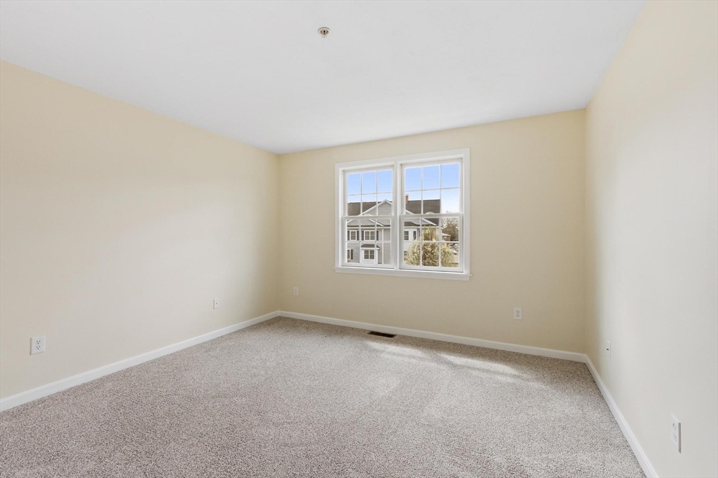 1975 Middlesex Street, Unit 33 Lowell, MA 01851 - Photo 12 of 18 an empty room with a empty space and window