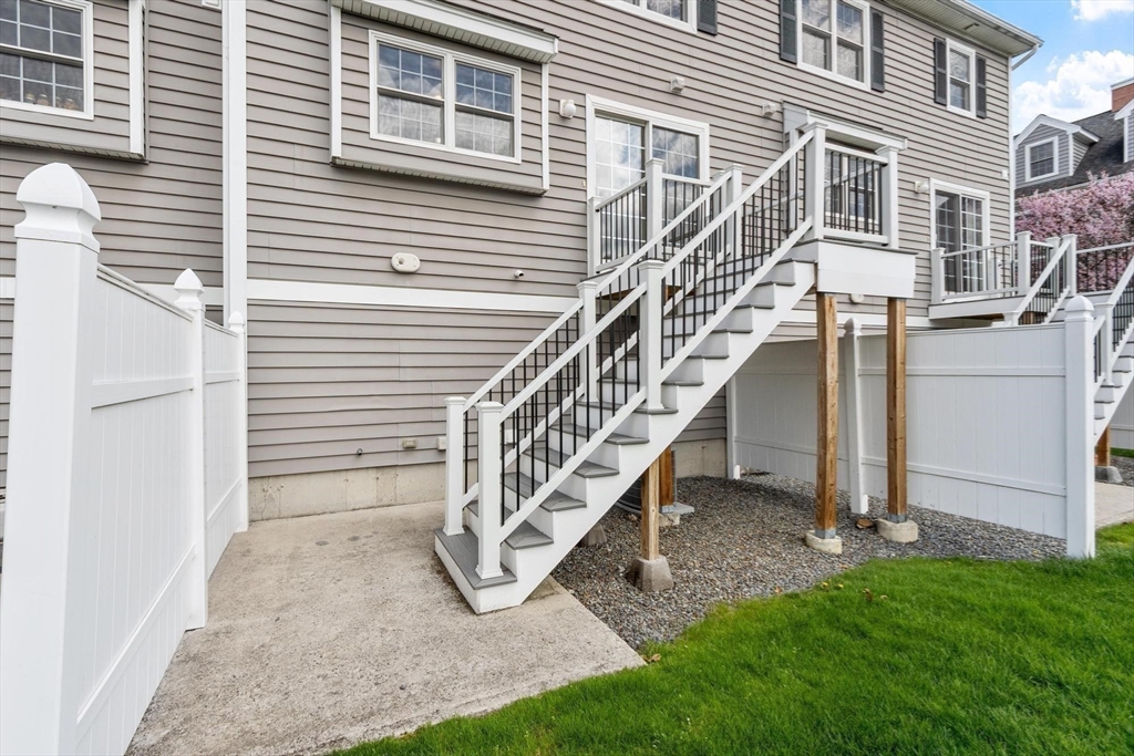 1975 Middlesex Street, Unit 33 Lowell, MA 01851 - Photo 16 of 18 a view of a house with a yard and stairs