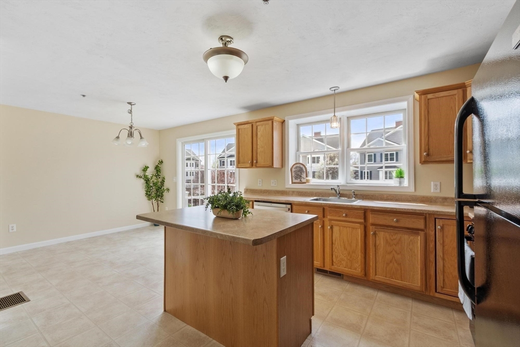 1975 Middlesex Street, Unit 33 Lowell, MA 01851 - Photo 2 of 18 a kitchen with stainless steel appliances granite countertop sink stove and refrigerator