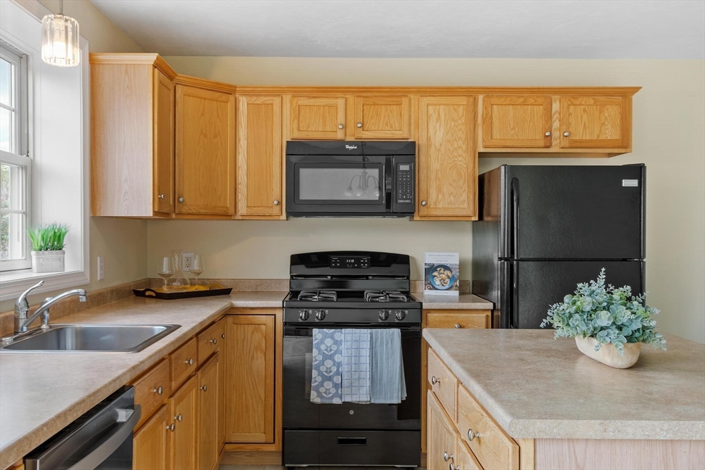 1975 Middlesex Street, Unit 33 Lowell, MA 01851 - Photo 3 of 18 a kitchen with granite countertop cabinets stainless steel appliances and a counter space