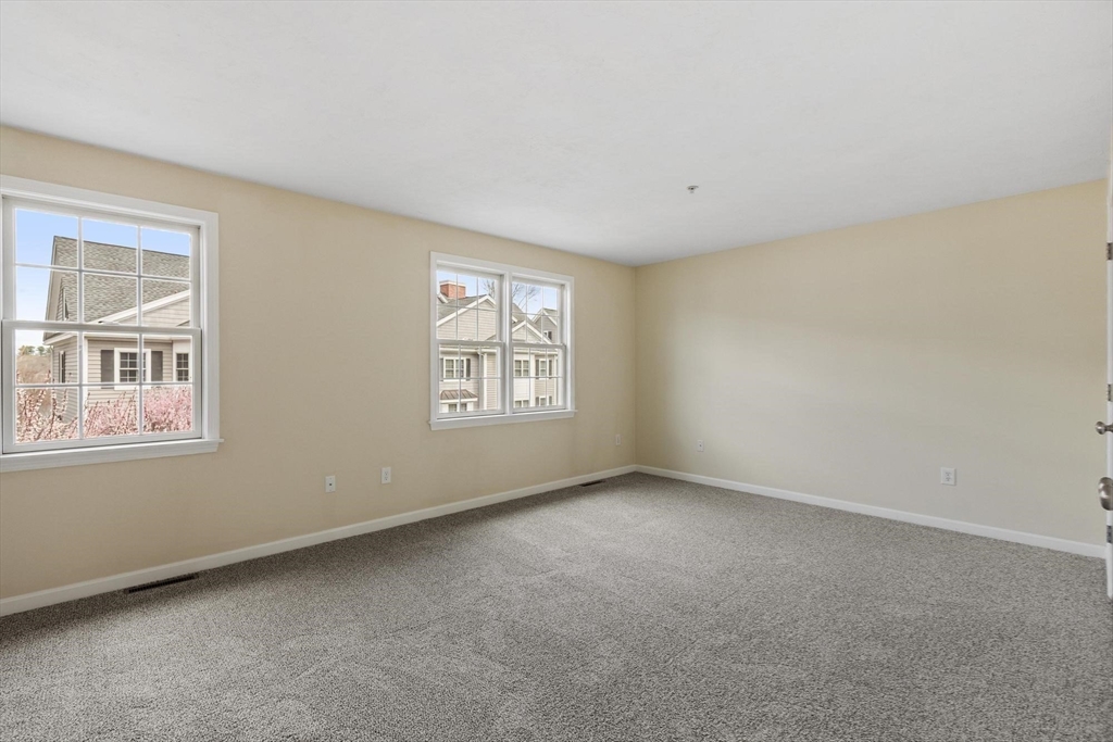 1975 Middlesex Street, Unit 33 Lowell, MA 01851 - Photo 9 of 18 an empty room with windows