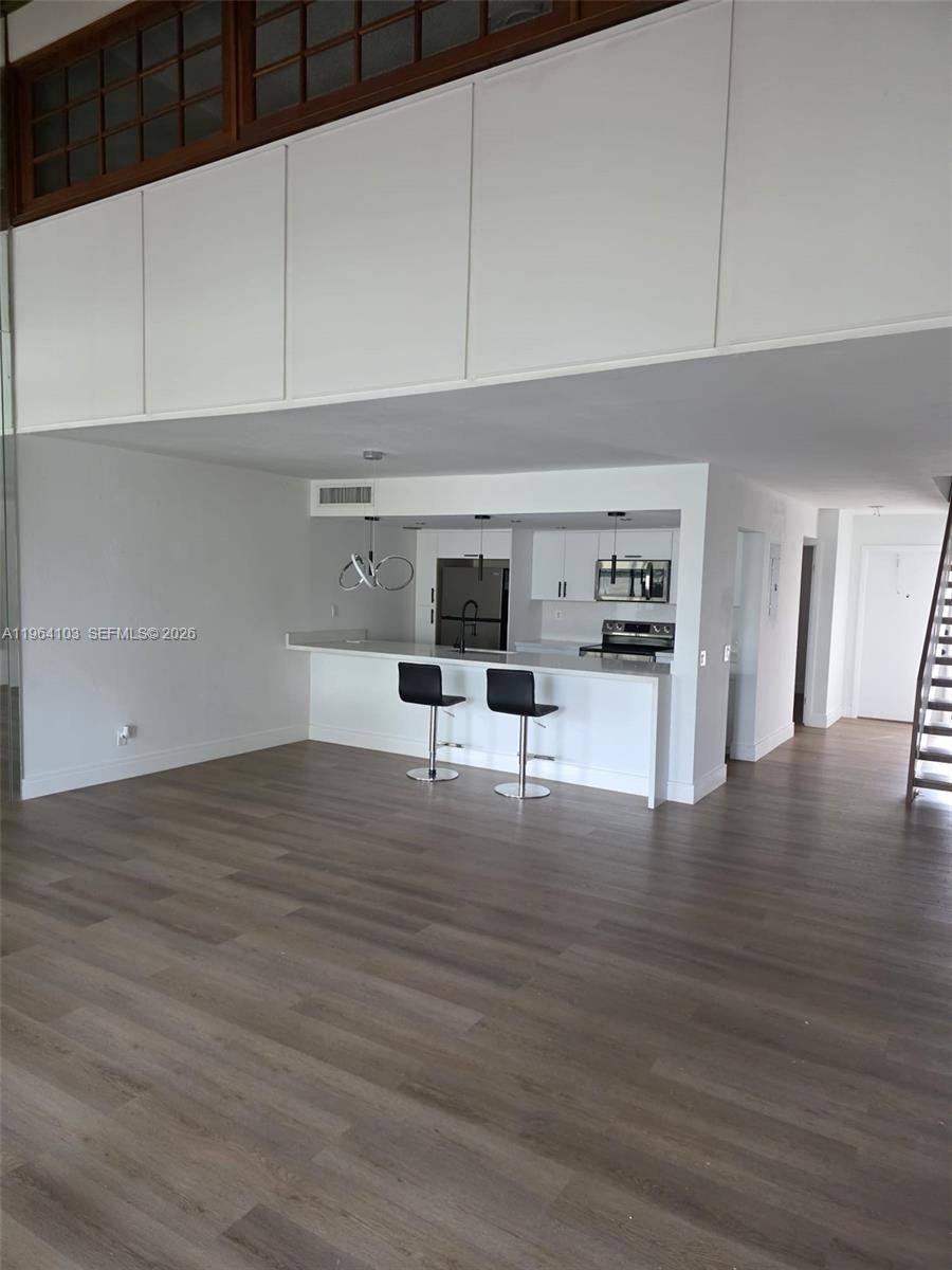 10951 Cypress Road, Unit 10951 Pembroke Pines, FL 33026 - Photo 13 of 27 a view of kitchen with furniture and wooden floor