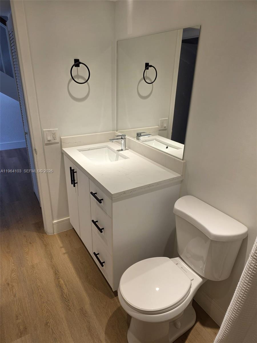 10951 Cypress Road, Unit 10951 Pembroke Pines, FL 33026 - Photo 15 of 27 a bathroom with a toilet sink and mirror