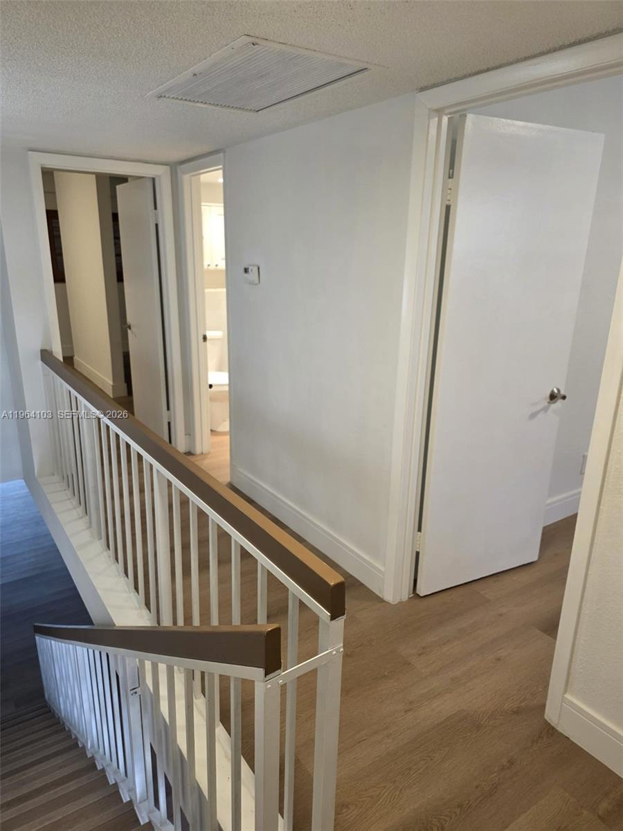 10951 Cypress Road, Unit 10951 Pembroke Pines, FL 33026 - Photo 18 of 27 a view of staircase with railing and white walls