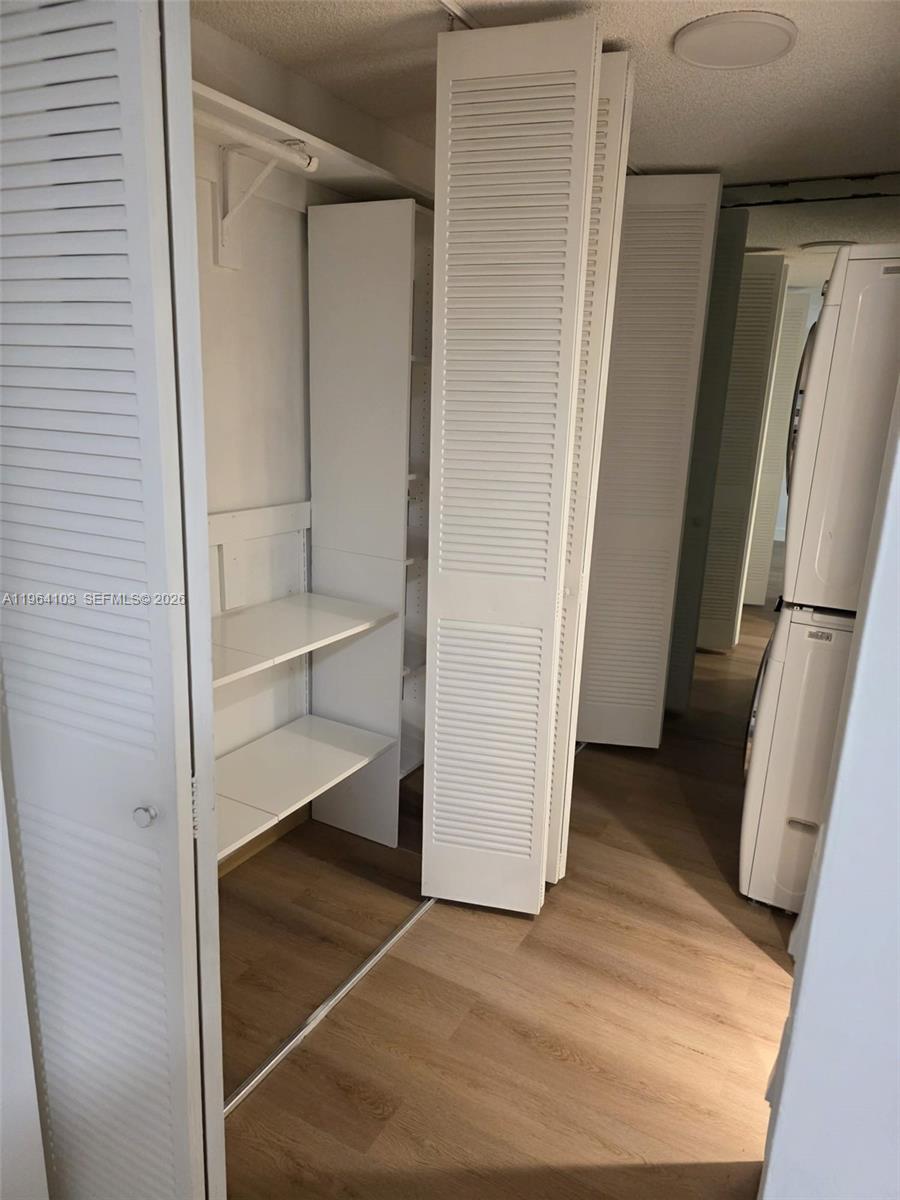 10951 Cypress Road, Unit 10951 Pembroke Pines, FL 33026 - Photo 24 of 27 a view of walk in closet with empty racks