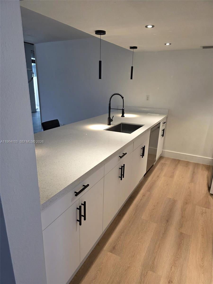 10951 Cypress Road, Unit 10951 Pembroke Pines, FL 33026 - Photo 4 of 27 a kitchen with stainless steel appliances a sink and cabinets