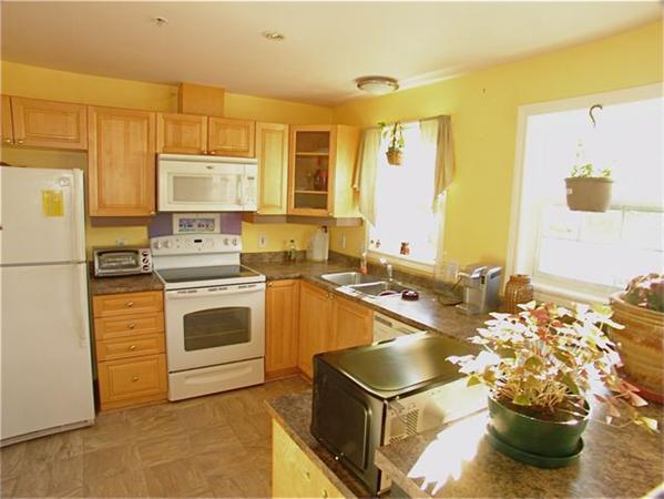 32 Junction Street, Unit 2 Needham, MA 02492 - Photo 2 of 17 a kitchen with a stove a sink and a refrigerator