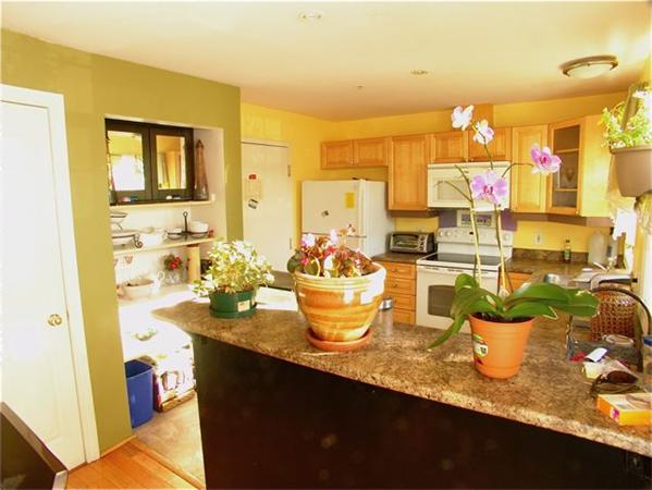 32 Junction Street, Unit 2 Needham, MA 02492 - Photo 3 of 17 a kitchen with a table and chairs