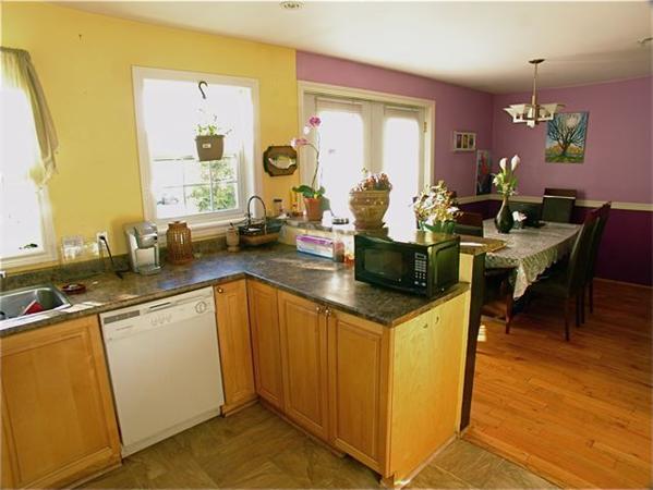 32 Junction Street, Unit 2 Needham, MA 02492 - Photo 5 of 17 a kitchen with a sink a counter top space and living room area