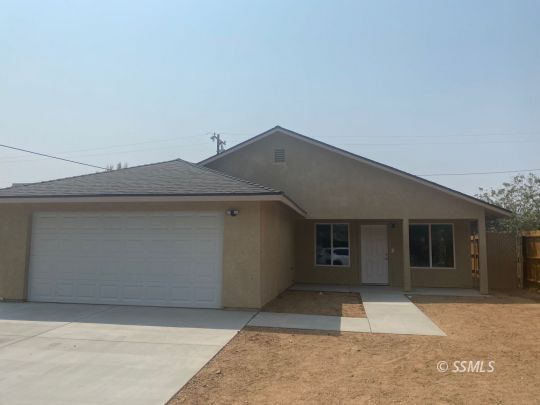 1009 West Boston Avenue Ridgecrest, CA 93555 - Photo 1 of 9 a front view of a house with garage