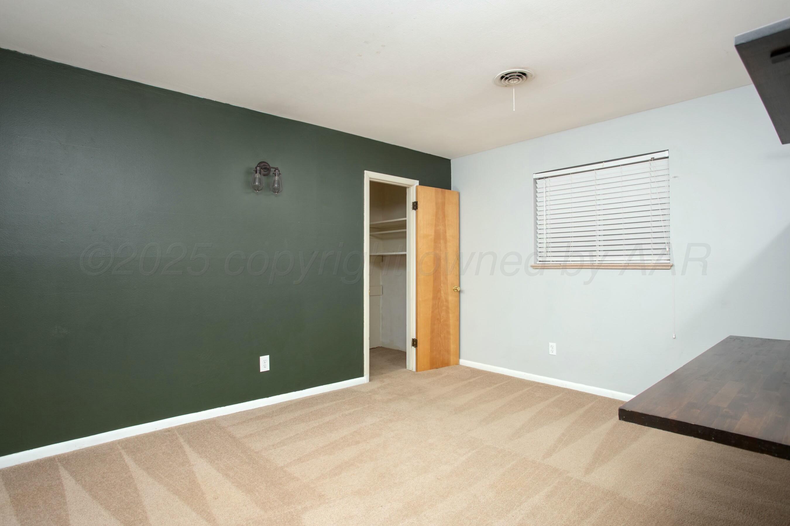 3621 Thurman Street Amarillo, TX 79109 - Photo 15 of 29 a view of an empty room with closet and a window