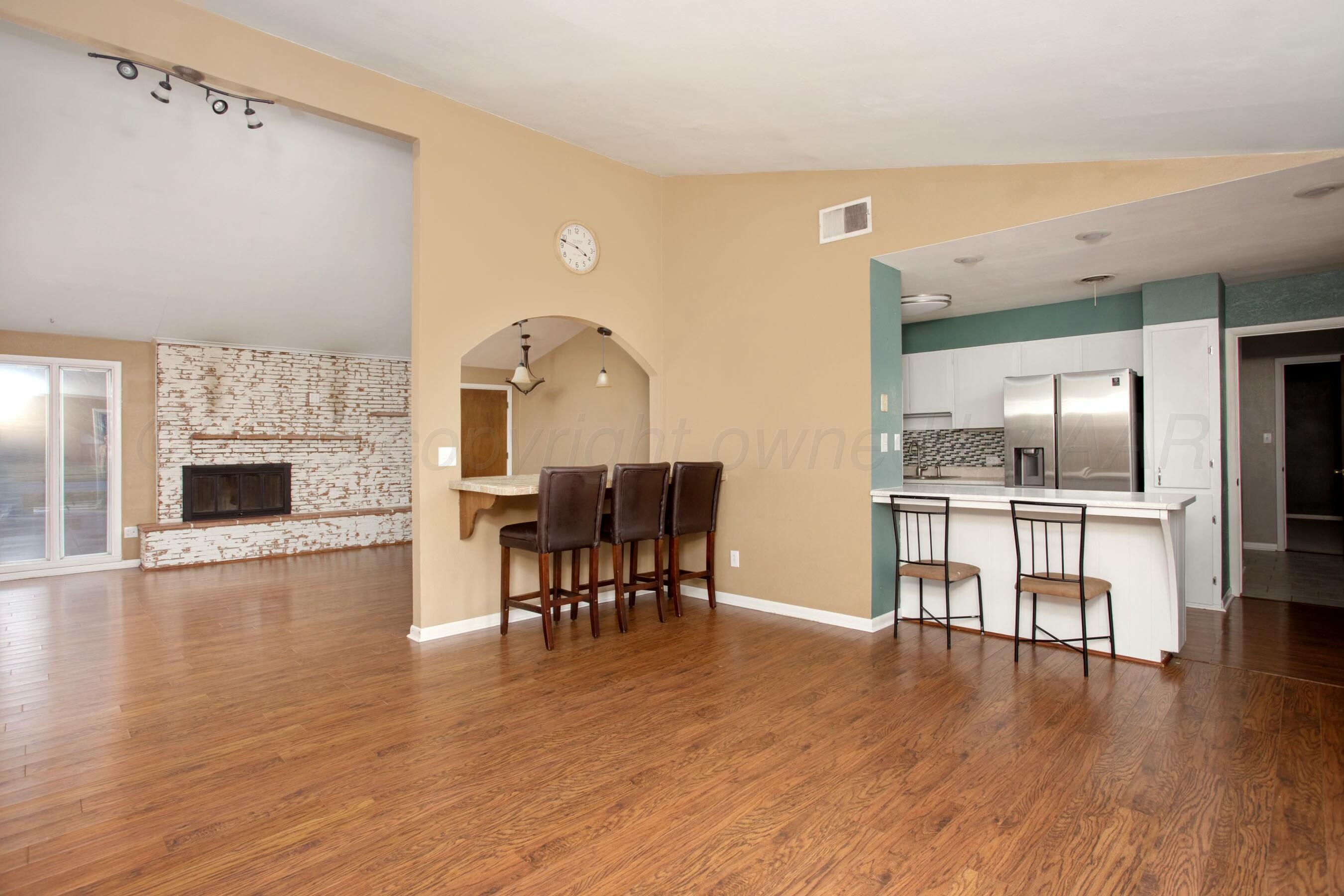 3621 Thurman Street Amarillo, TX 79109 - Photo 7 of 29 a living room with furniture wooden floor and a fireplace