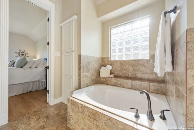 a bathroom with a tub and shower