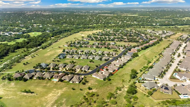 an aerial view of residential building and lake