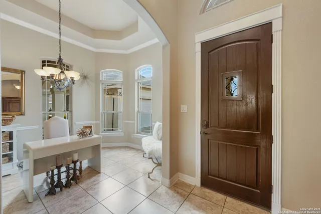 a view of a hallway with dining table and chairs