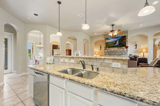a large kitchen with a sink and a large area of living room
