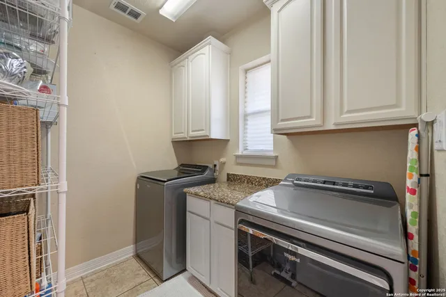 a kitchen with a stove and a white cabinet