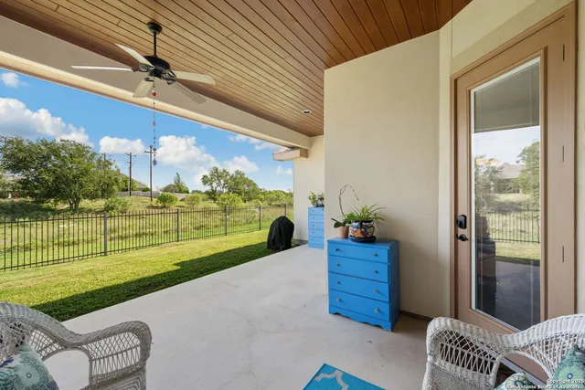 a balcony with furniture and garden view