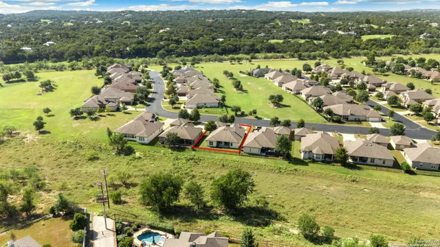 an aerial view of residential houses with outdoor space