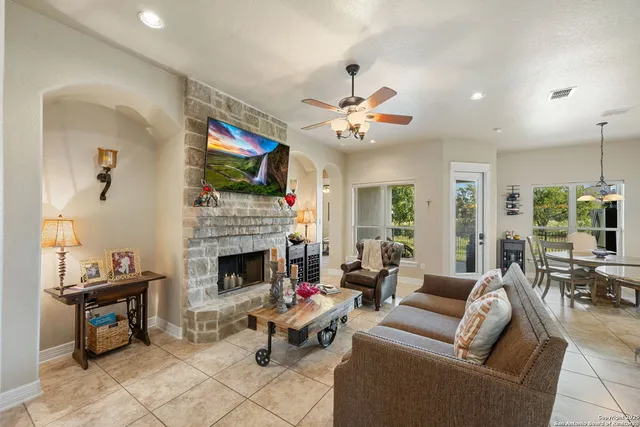 a living room with furniture a fireplace and a flat screen tv
