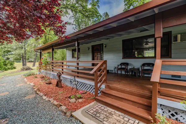 a view of a backyard with sitting area