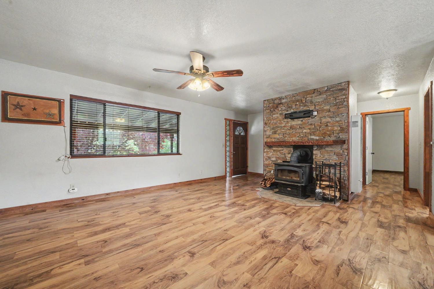 4821 Old Emigrant Trail East Mountain Ranch, CA 95246 - Photo 11 of 65 an empty room with furniture and a fireplace