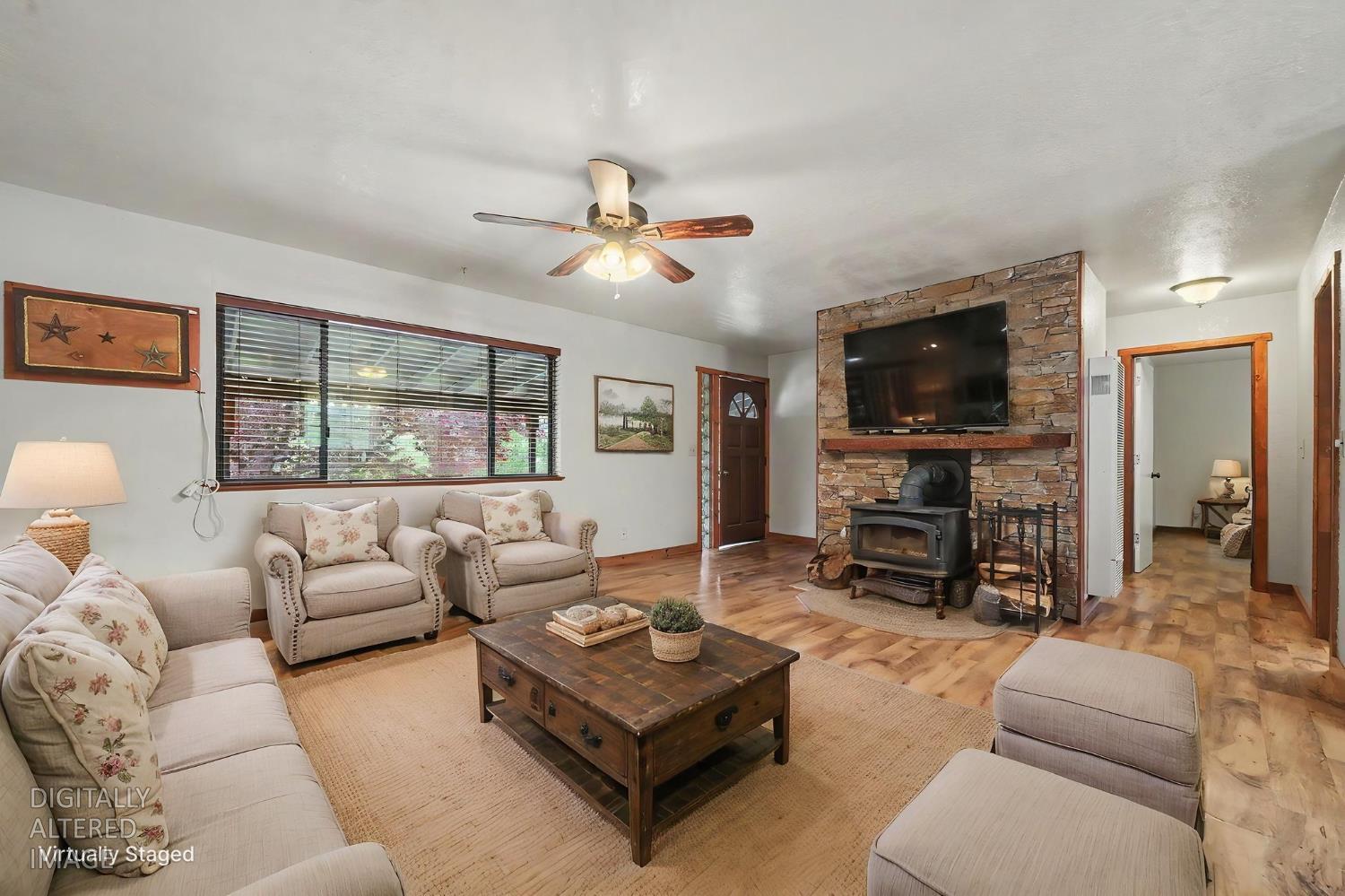 4821 Old Emigrant Trail East Mountain Ranch, CA 95246 - Photo 12 of 65 a living room with furniture a flat screen tv and a large window