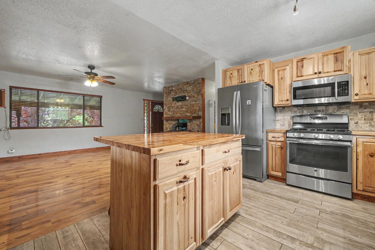 4821 Old Emigrant Trail East Mountain Ranch, CA 95246 - Photo 18 of 65 a kitchen with stainless steel appliances granite countertop a stove and a refrigerator