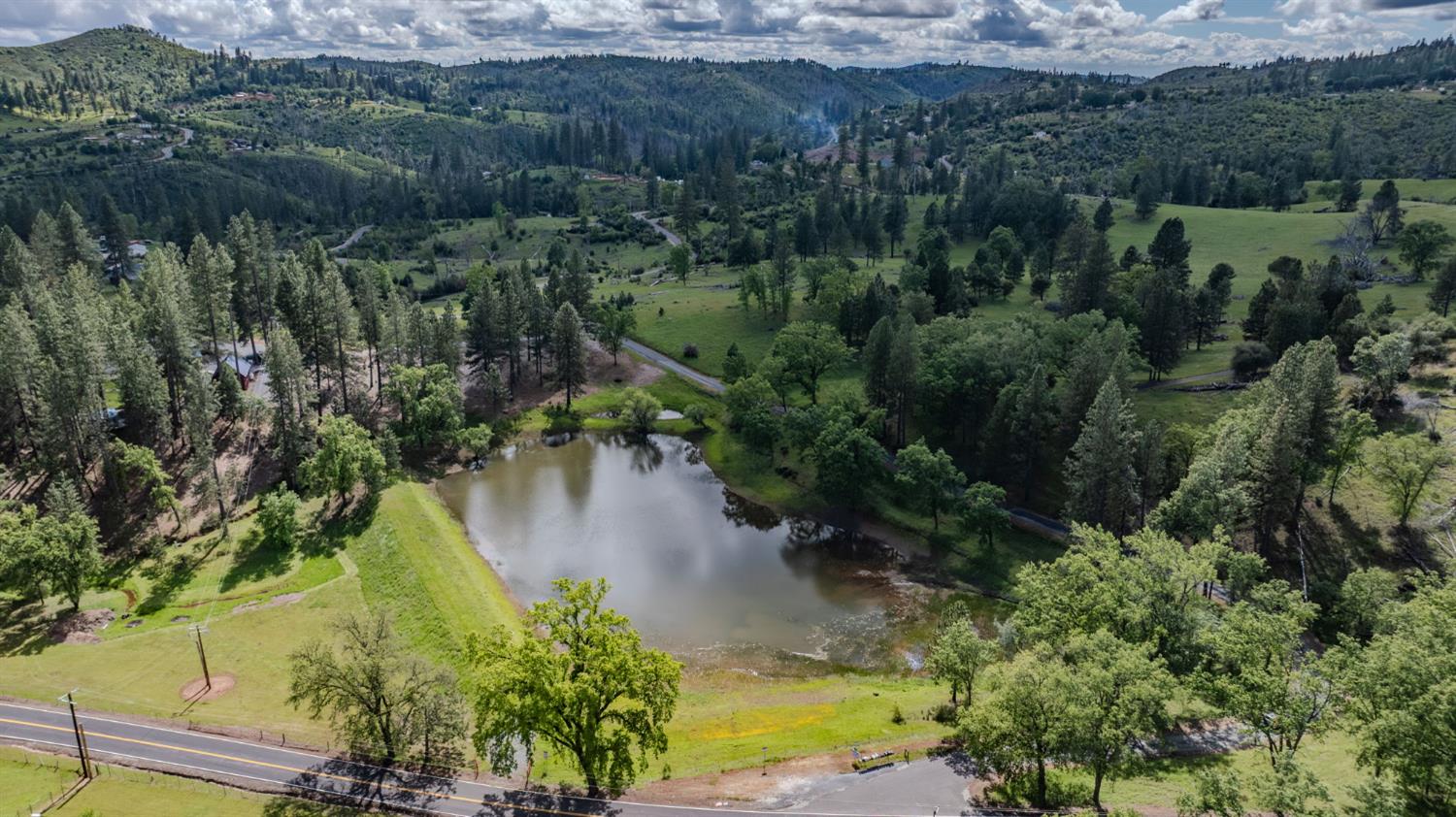 4821 Old Emigrant Trail East Mountain Ranch, CA 95246 - Photo 65 of 65 a view of a lake with green landscape and trees