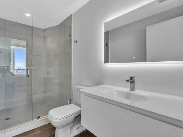 a large kitchen with kitchen island a sink stainless steel appliances and a counter top space