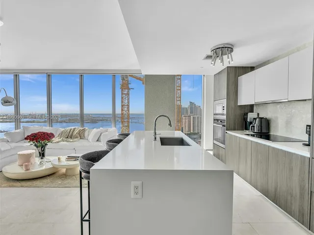 a kitchen with stainless steel appliances granite countertop a sink and cabinets