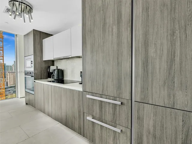 a bathroom with a glass door shower a sink and a mirror