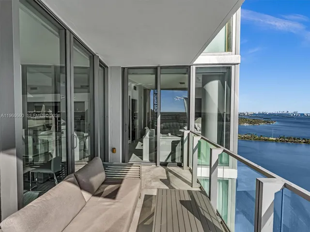 a green field with view of tall buildings