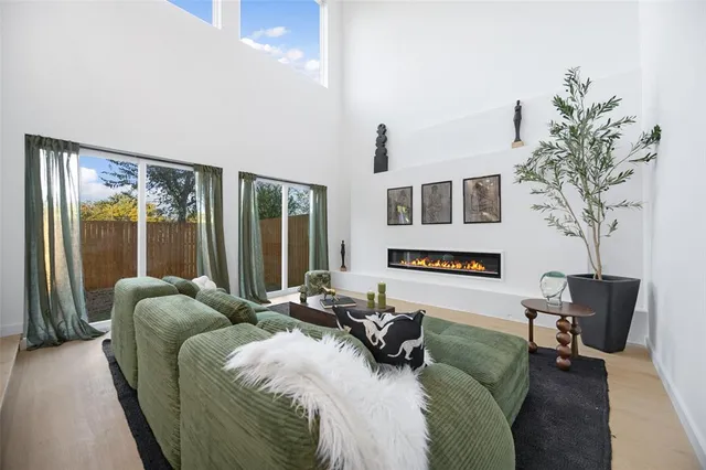 a bedroom with furniture and a large window