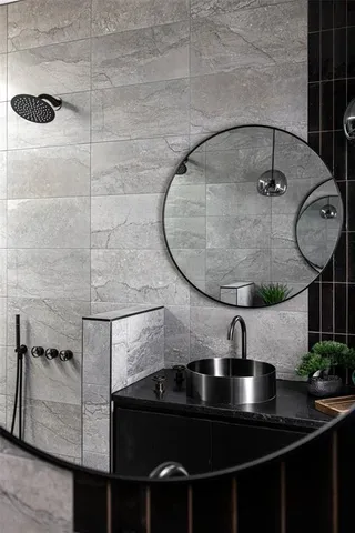 a hallway with white cabinets and a refrigerator
