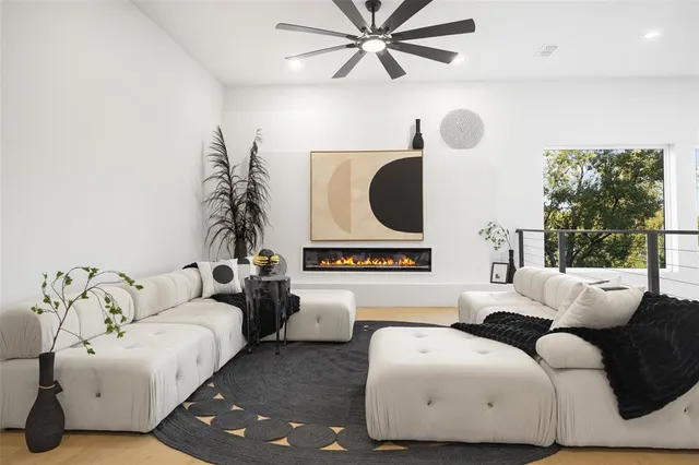 a living room with a bed furniture and a potted plant