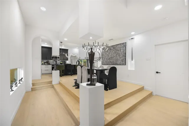 a view of a dining room with furniture a chandelier and wooden floor