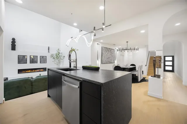 a kitchen with stainless steel appliances kitchen island a stove a sink a oven and a refrigerator