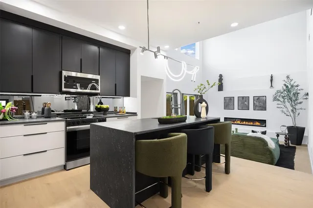 a kitchen with a table chairs refrigerator and microwave