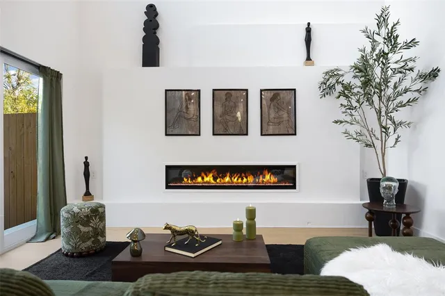 a living room with furniture and a potted plant