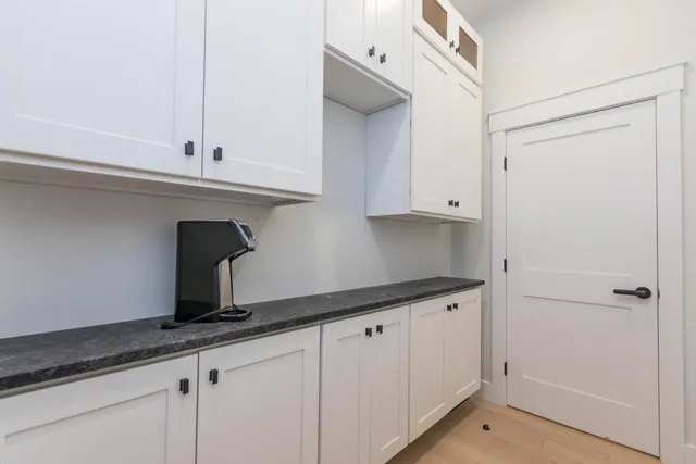 a kitchen with stainless steel appliances granite countertop a sink a stove and a wooden floor