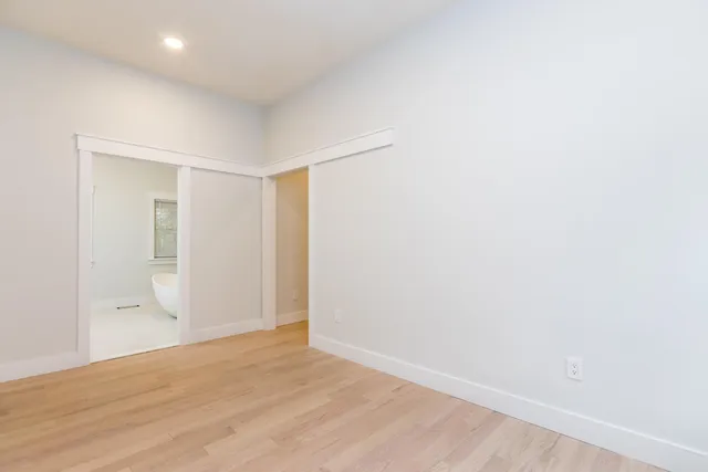 a bedroom with a large bed and a flat tv screen