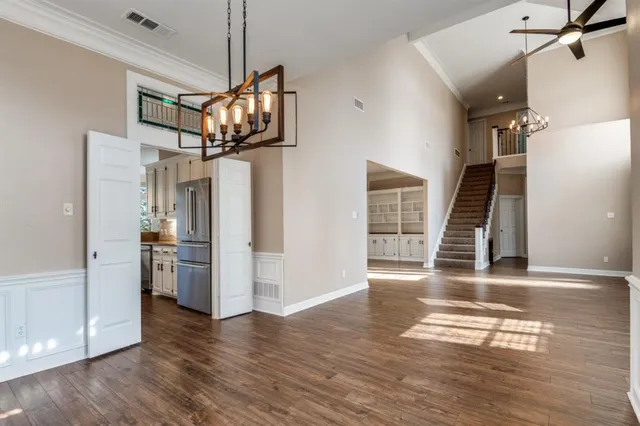 a kitchen with a sink wooden floor and window