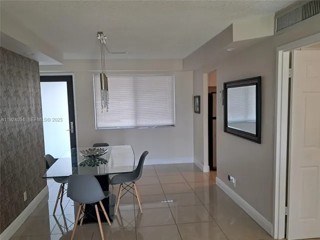 a view of a room with furniture and wooden floor