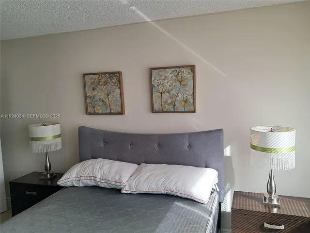 a bedroom with a bed and a lamp on table