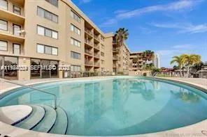 a swimming pool with outdoor seating and yard