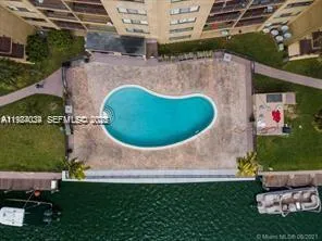 a view of a swimming pool with a yard and plants